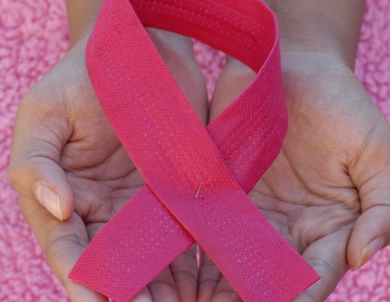 person with pink band on her left hand